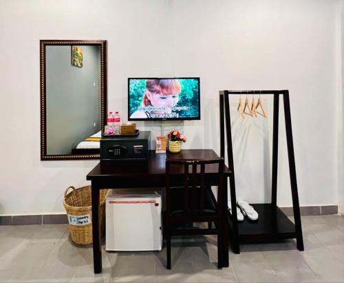 a dressing table with a mirror at Sun Chakra Boutique Hotel - 50m to Museum & Royal Palace & Walking street in Phnom Penh