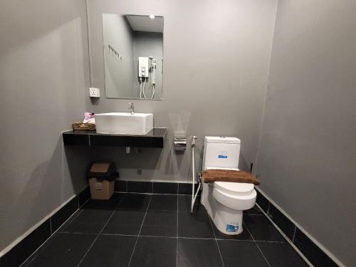 a bathroom with a white toilet and a sink at Sun Chakra Boutique Hotel - 50m to Museum & Royal Palace & Walking street in Phnom Penh