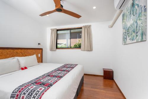 a bedroom with a bed and a ceiling fan at Atupa Suites in Avatiu