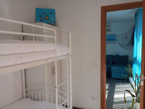 a room with two bunk beds and a mirror at Paraíso de la Costa Brava in Portbou