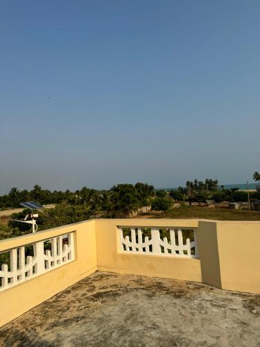 a house with a white fence on top of it at Ramaya Auberge Espagnole in Grand-Popo