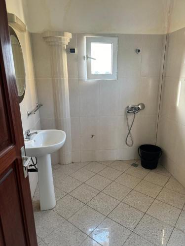 a bathroom with a sink and a shower at Ramaya Auberge Espagnole in Grand-Popo