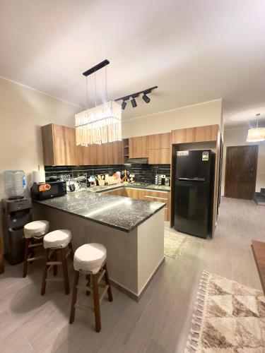 a kitchen with a black refrigerator and a counter at Luxury Villa Bali Al Gouna Hurgh in Hurghada