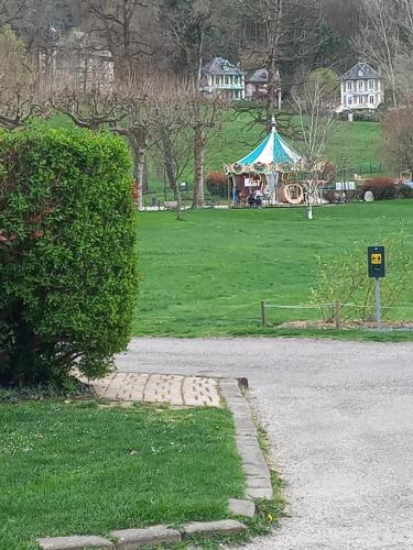 a park with a gazebo in the background and a grass field at Residence du parc in Saint-Martin-dʼUriage