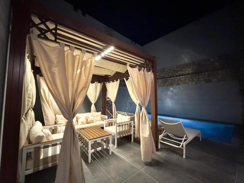 a room with a bed and a couch and a chair at Luxury Villa Bali Al Gouna Hurgh in Hurghada