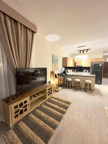 a living room with a large television and a kitchen at Luxury Villa Bali Al Gouna Hurgh in Hurghada