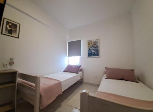 a bedroom with two beds and a dresser in it at Apartments Finera in Pomer