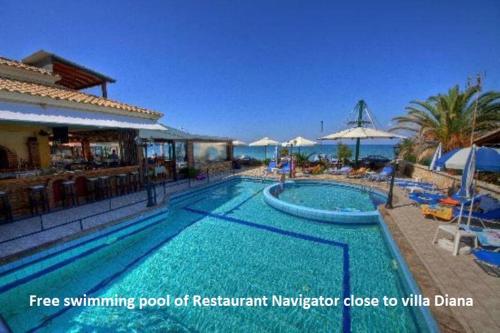 a swimming pool of a restaurant margaritator close to villa drama at Villa Diana in Acharavi