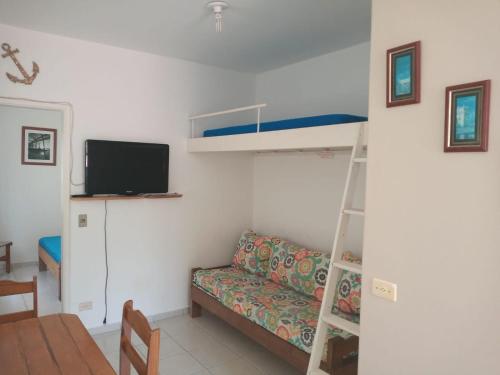 a living room with a couch and a bunk bed at Pousada/Flat Praia Do Sonho in Itanhaém
