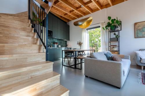 a living room with a staircase and a couch at Le Resort, charmante petite villa d'architecte in Saint-Jean-de-Védas