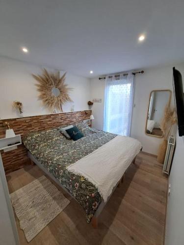 une chambre avec un lit et un miroir au mur dans l'établissement Appartement cosy à Créteil., à Créteil