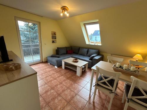 a living room with a couch and a table at K&S Ferienwohnungen in Dierhagen