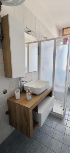 a bathroom with a sink and a tub and a mirror at Il bacio del sole in Campomarino