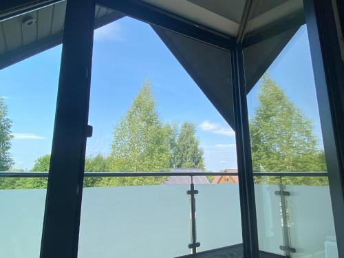 a view from the window of a building with trees at Lazurowy Brzeg in Przejma Wielka