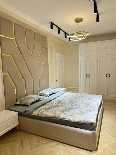 a bedroom with a large bed in a room at Lux 3-roomed apartment close to the Registan Amaliapartment in Samarkand