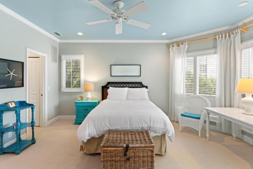 a bedroom with a bed and a ceiling fan at The Coral Door Beach House - 4315 Fourth Street in Saint Simons Island