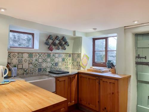 a kitchen with a sink and a counter top at Bonsall View Cottage in Bonsall