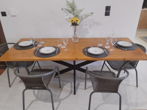 a wooden table with chairs and a vase of flowers on it at XΡΗΣΤΟΣ house in Ioannina