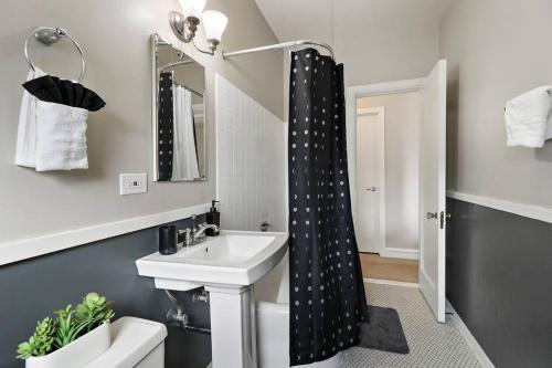 a bathroom with a sink and a shower curtain at Calm & Cozy 1BR Furnished Apartment in Hyde Park - Windermere 402 in Chicago