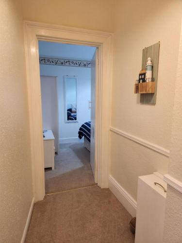 a hallway with a door leading to a bedroom at Rose Court Holiday Apartments in Torquay