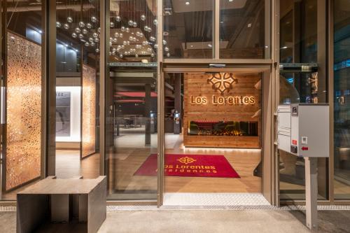 a glass building with a los lorenos sign on the door at NEW OPENING 2022 - Los Lorentes Apartments Bern City in Bern