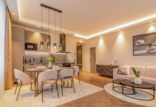 a living room with a table and chairs and a couch at City Panorama with SAUNA in Tartu