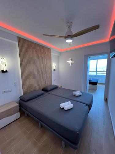 a bedroom with two beds with towels on them at Hany apartment Tropic mar 18-C in Benidorm