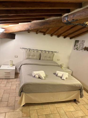 a bedroom with a large bed with two towels on it at Il Nido di Fede e Romy in Castelnuovo Berardenga