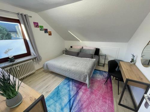 a bedroom with a bed and a couch and a table at Grace Apartment in Grömitz