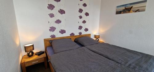 a bedroom with a bed with two pillows on it at Brockenblick in Altenau