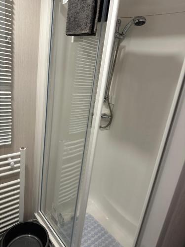 a shower with a glass door in a bathroom at LOIRE in Skegness