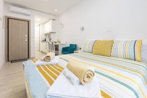 a bedroom with a large bed with towels on it at Studio apartman Medvedgrad in Zagreb