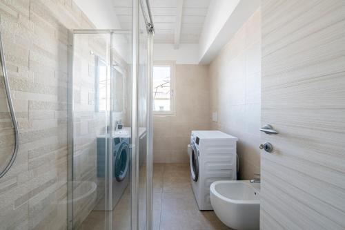 a bathroom with a shower and a toilet and a sink at Appartamento Luxury vista mare in Lido di Camaiore