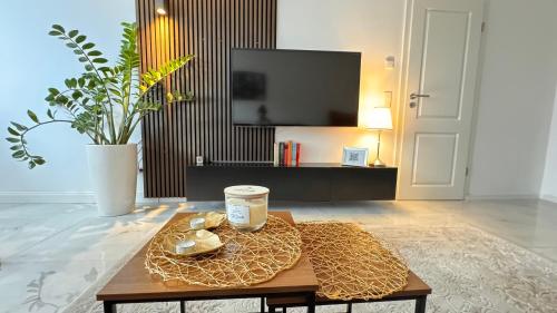 a living room with a coffee table and a tv at RelaxDays-Apartments in Gütersloh