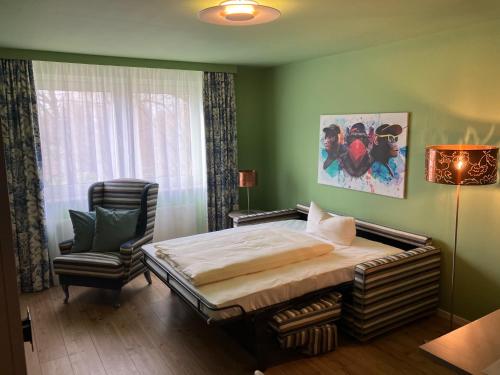 a bedroom with a bed and a chair in it at HomeSweetHome Wedel in Wedel