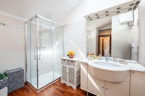 a bathroom with a sink and a shower at Attico Viareggio Centro in Viareggio