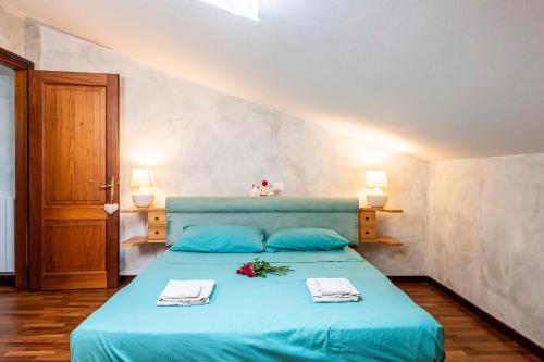 a bedroom with a blue bed with flowers on it at Attico Viareggio Centro in Viareggio
