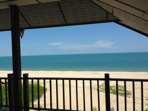 a view of the beach from a balcony at Sea Breeze House, Naiplao Beach in Khanom