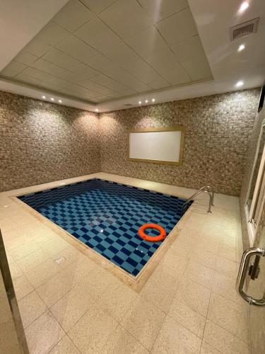 a large swimming pool with an orange object in it at شاليهات حديقة الوسام لبيوت العطلات 1 in Taif