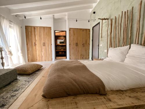 a bedroom with a large bed and wooden floors at Casa Timbale in Felanitx