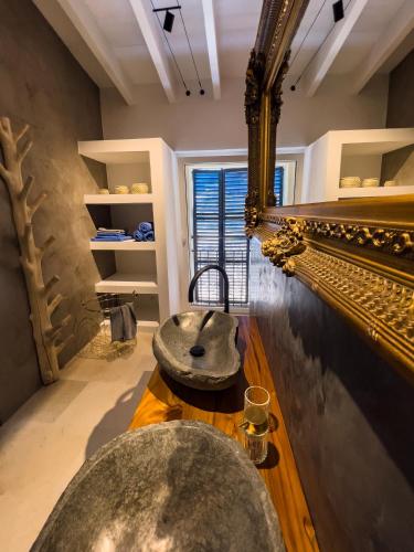 a bathroom with a large mirror and a sink at Casa Timbale in Felanitx