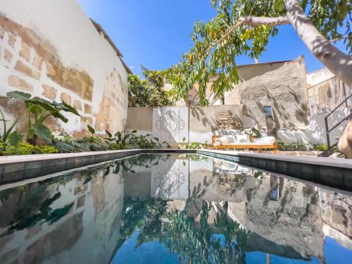 an infinity pool in the backyard of a house at Casa Timbale in Felanitx
