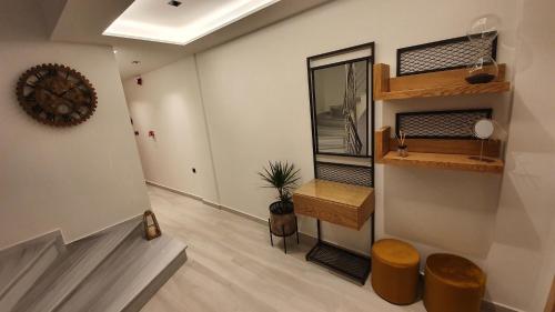 a room with a hallway with a table and a mirror at MELIGEO APARTMENTS CENTER of IOANNINA in Ioannina