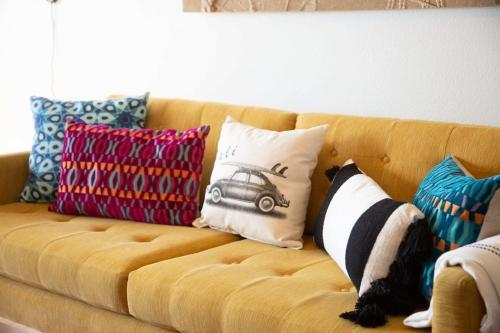 a brown couch with pillows on top of it at Solana Beach Sol condo in Solana Beach