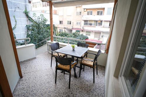 a balcony with a table and chairs on a balcony at Near Center Apartments 3 in Tirana