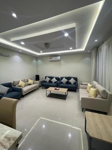 a large living room with couches and a table at شاليهات حديقة الوسام لبيوت العطلات 1 in Taif