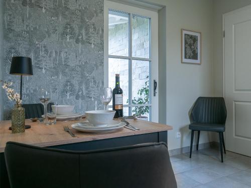 a table with a bottle of wine and a glass at Moserhof in Wahlhausen