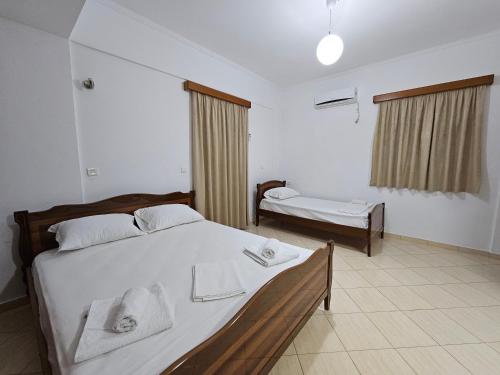a bedroom with a bed with towels on it at Guest House Bledar in Ksamil