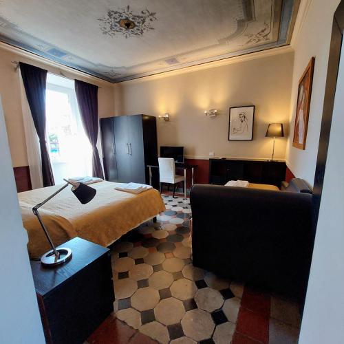 a hotel room with a bed and a couch at Residenza Maritti Decò Style- Guesthouse in Rome
