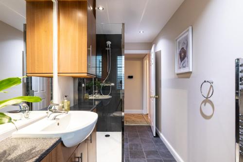 a bathroom with a sink and a shower at Apartment 91 in Inverness